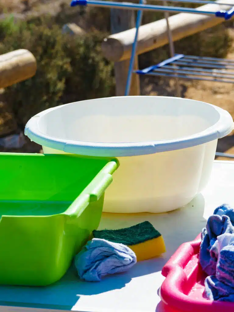 bowls of soapy water to wash clothes outside