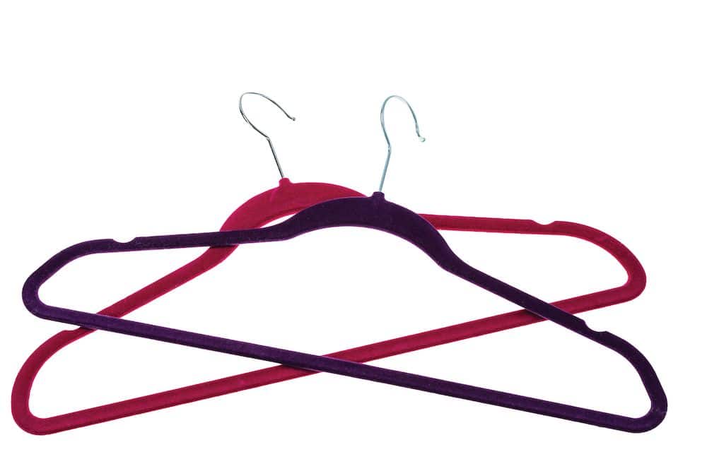 two velvet hangers on white background