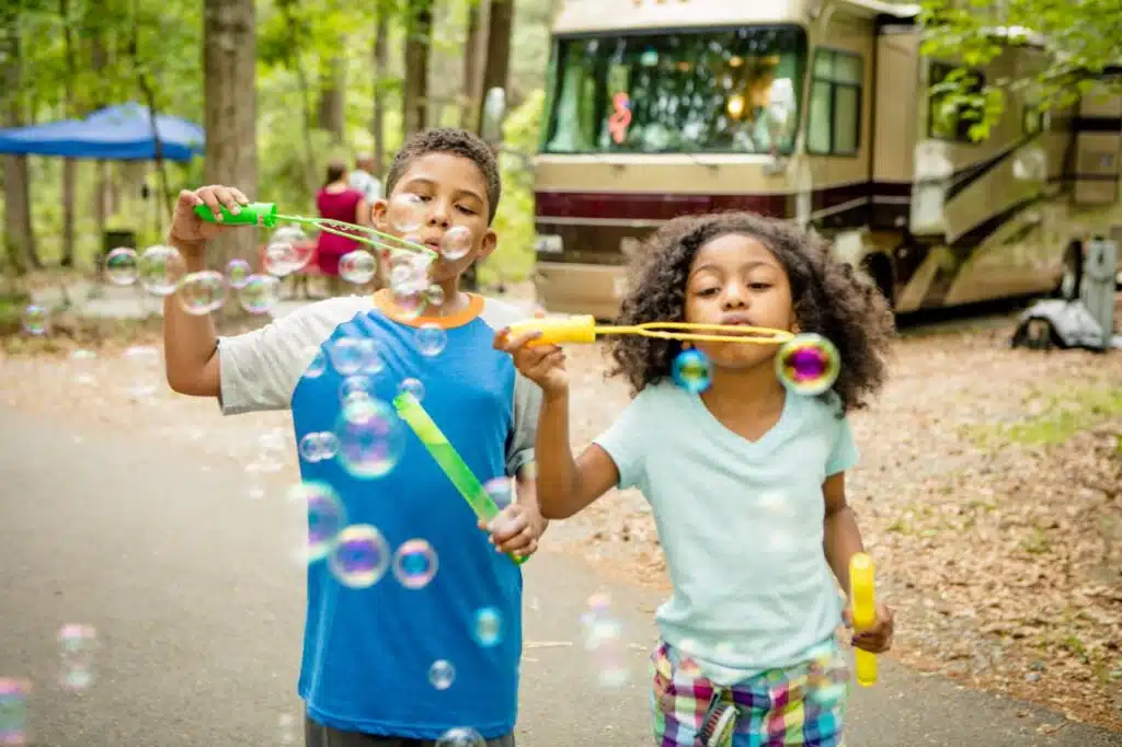 two kids blowing bubbles in RV campground near atlanta ga