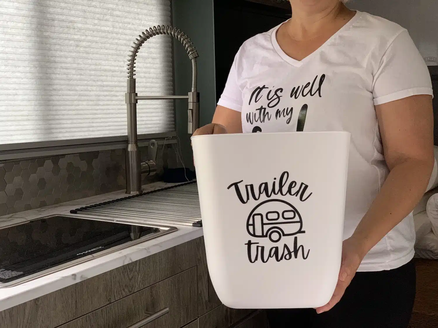woman holding a trailer trash can
