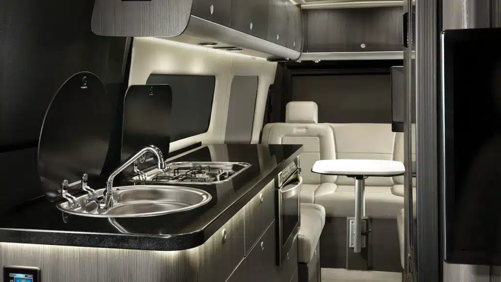 Airstream Interstate interior with white leather and grey cabinets