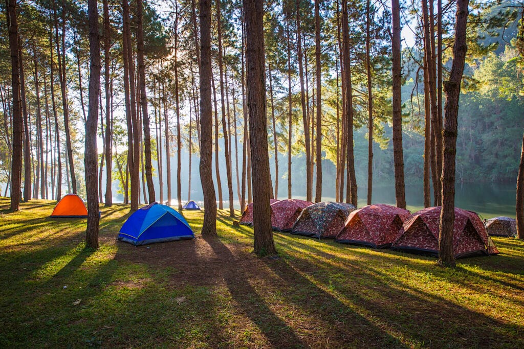 Campsite On Lake With Tents at Sunrise