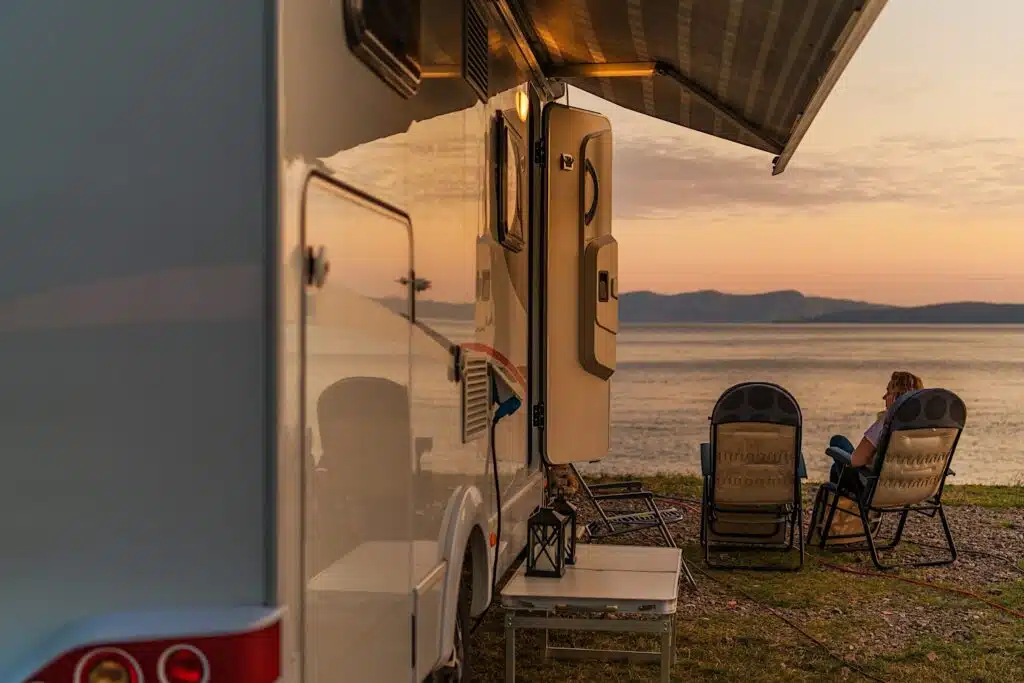 RV Awning By Lake At Sunset and lady in chair