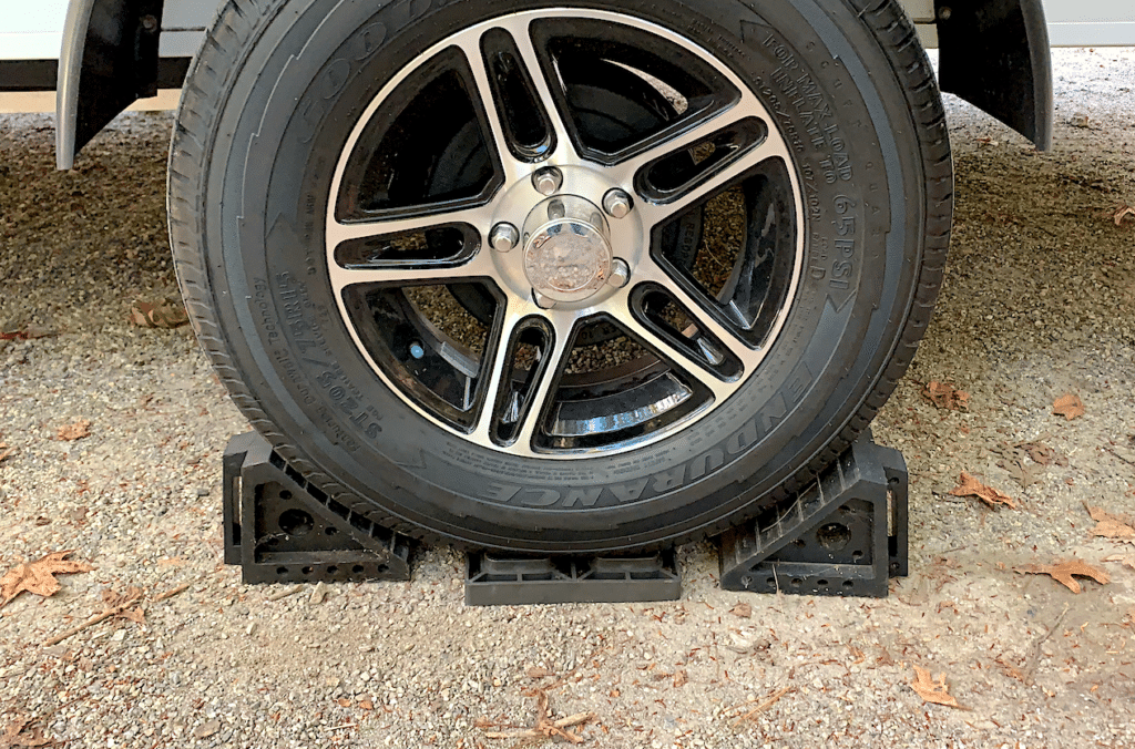 rv wheel with chocks on leveling block