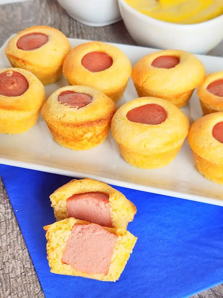 corn dog mini muffins on plate with blue napkin nearby