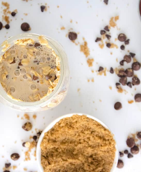 Cookie Dough Overnight Oats overhead on white table with chocolate chips