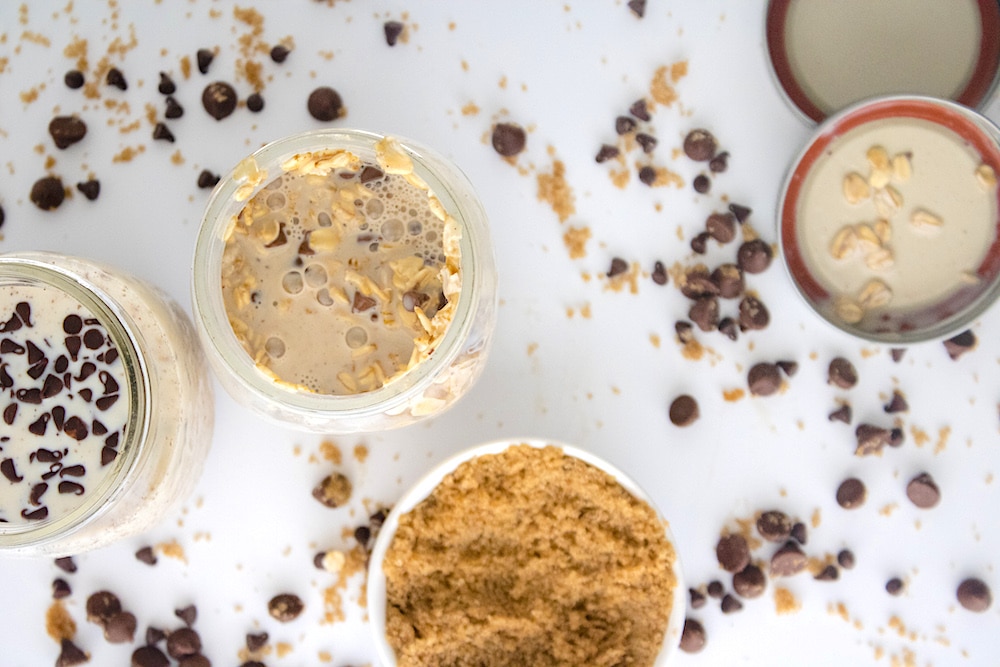 Cookie Dough Overnight Oats overhead on white table with chocolate chips