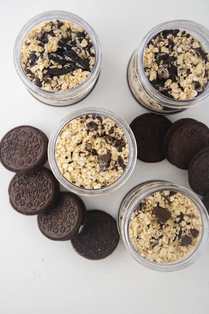 Cookies N Creme Overnight Oats overhead with Oreo cookies on white background