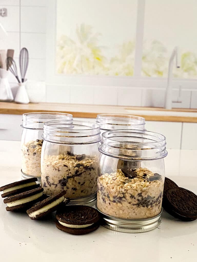 Cookies N Creme Overnight Oats in small jars on countertop