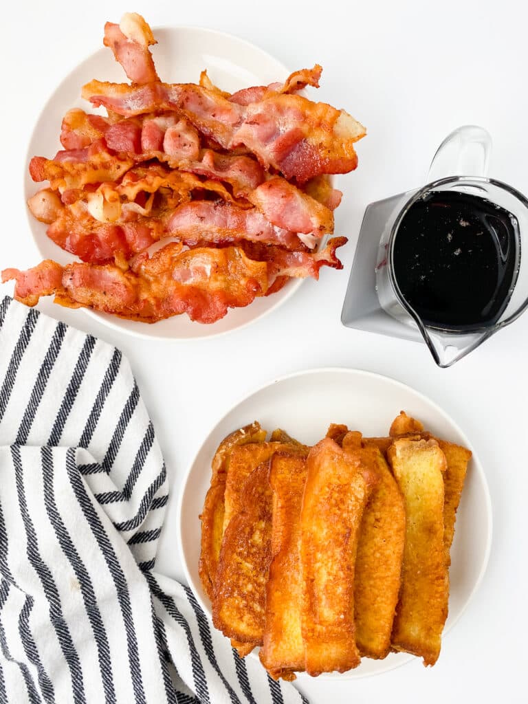 Copycat Burger King French Toast overhead with syrup and bacon white table