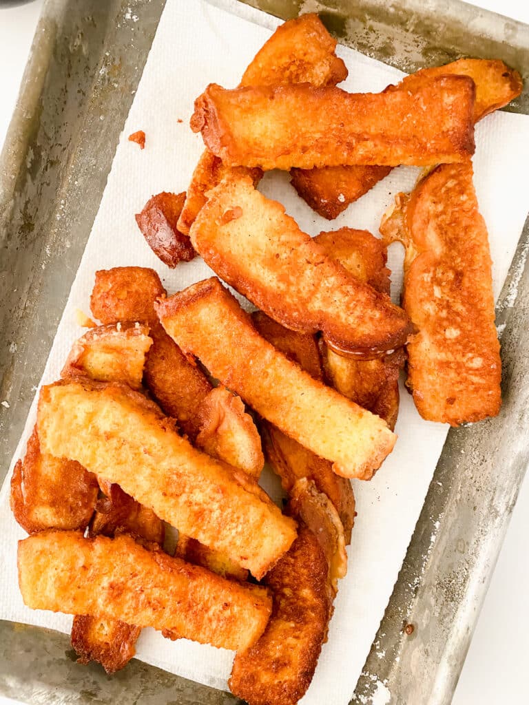 Copycat Burger King French Toast on white paper towel cooling