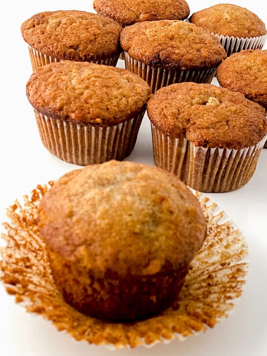 Easy Banana Nut Muffins in cupcake liners displayed against white background