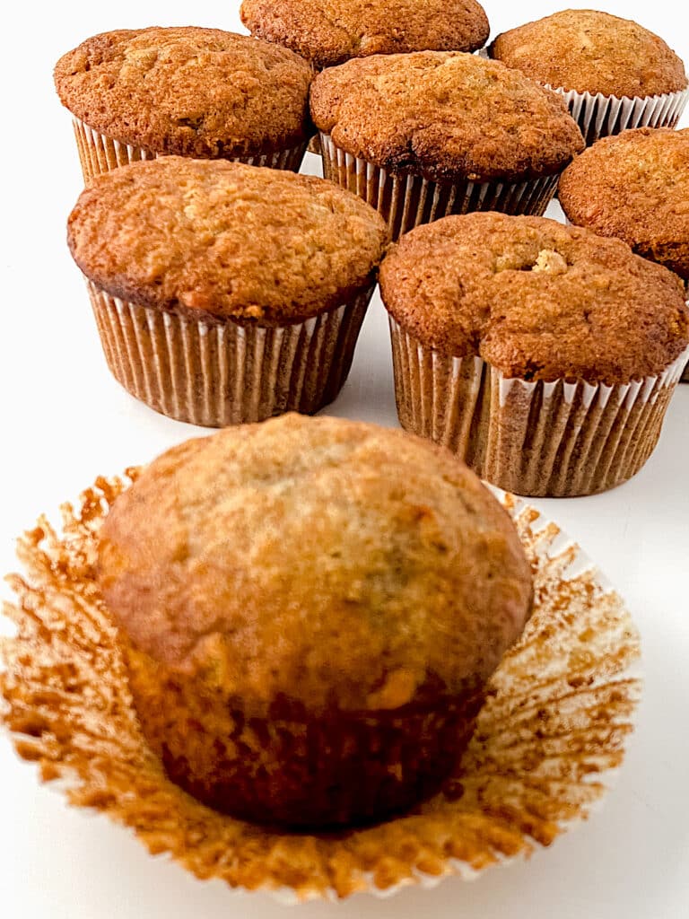 Easy Banana Nut Muffins in cupcake liners on white background