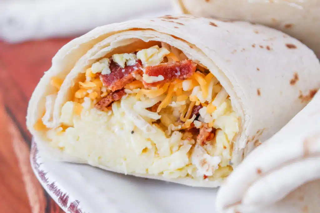 bacon, egg and cheese inside a wrapped tortilla