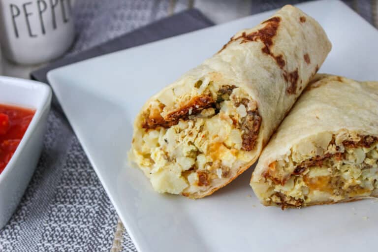 crock pot breakfast burrito cut in half on white plate