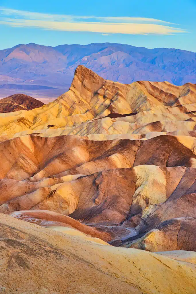 Image of Death Valley desert mountains filled with colorful sediment waves
