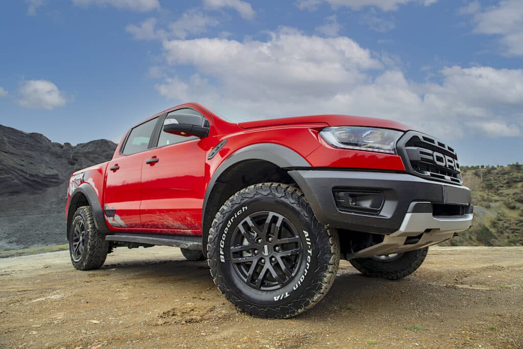 Ford Ranger Raptor sitting in mountains with red paint