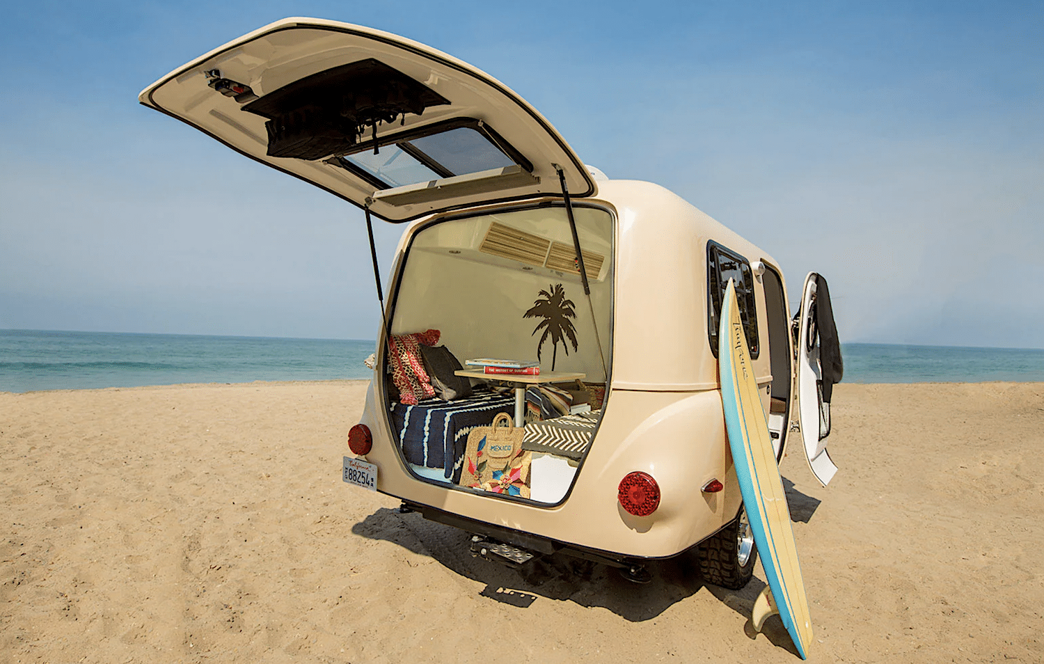 Happier Camper HC1 Beige color Sitting on sandy Beach with rear door open