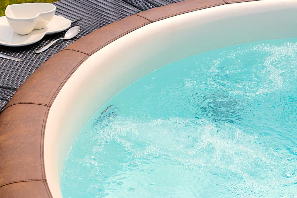 Closeup image of inflatable portable hot tub bubbling water surface