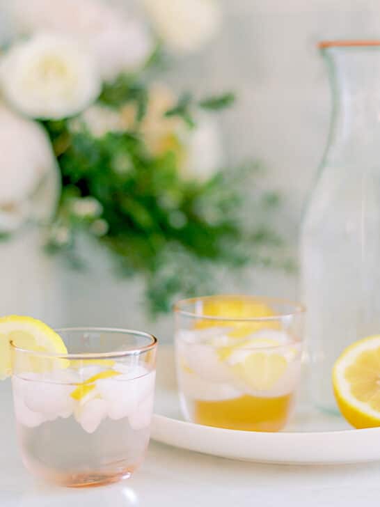 ice in glasses with lemon wedge on table with karaf