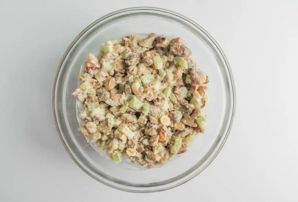 A glass bowl with a salad in it.