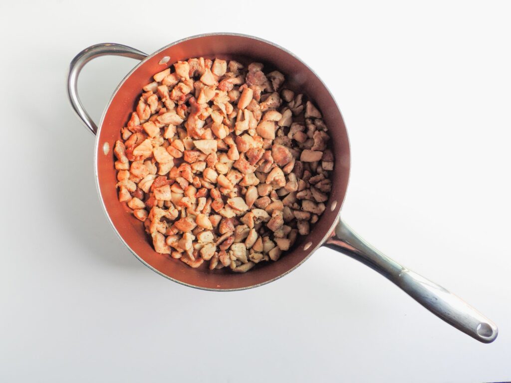 A pan full of nuts on a white surface.