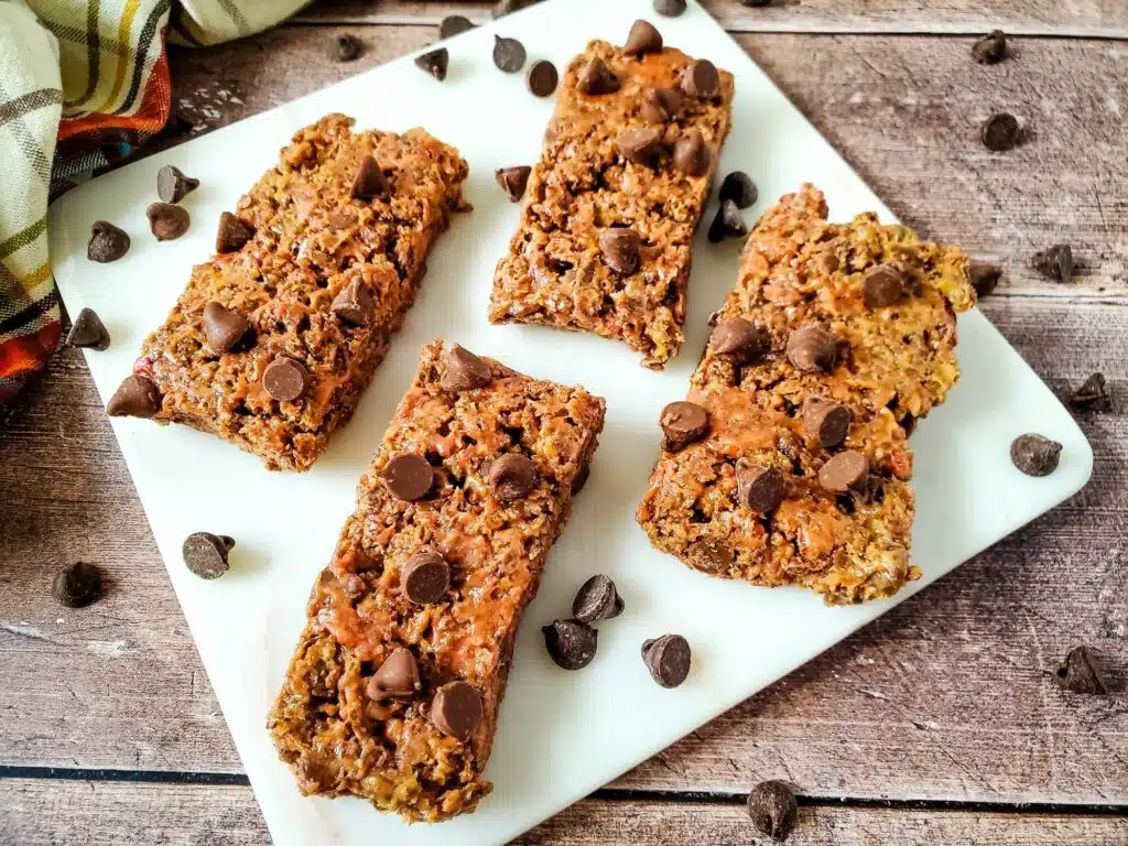 Pumpkin chocolate chip granola bars on a white plate.