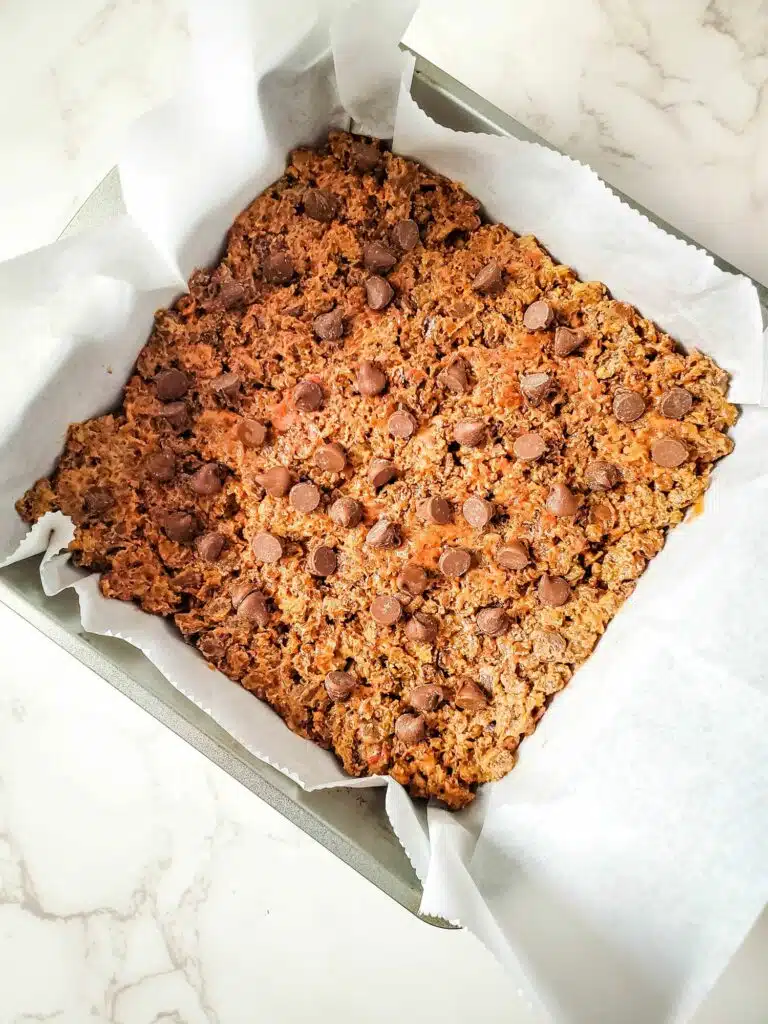 Chocolate chip cookie bars in a baking pan.