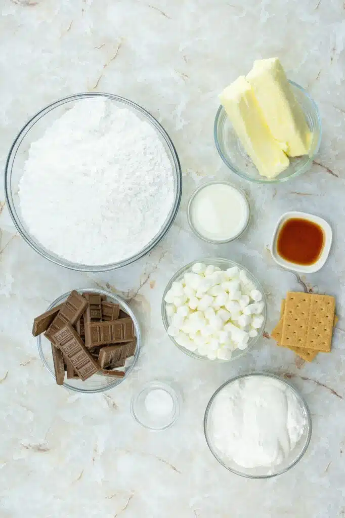 The ingredients for a s'mores dessert on a marble table.
