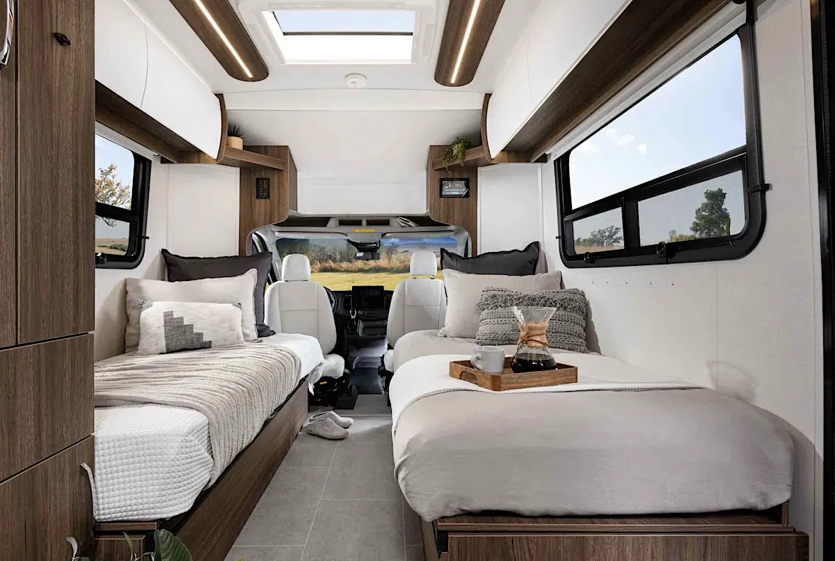Interior of rv with twin beds and sofa.