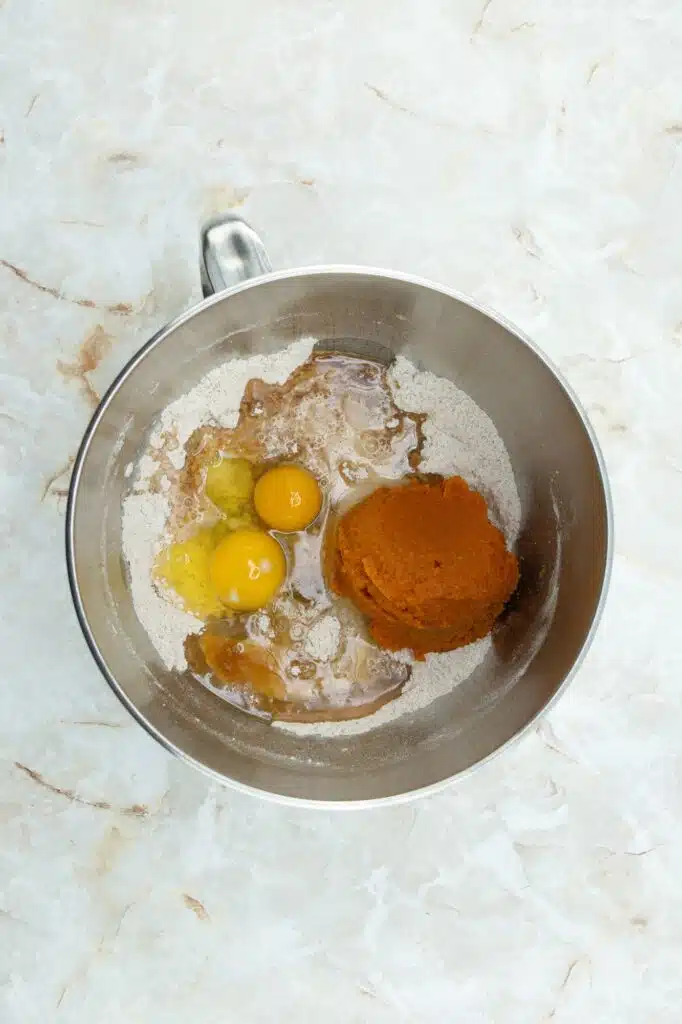 A bowl with flour, eggs and spices.