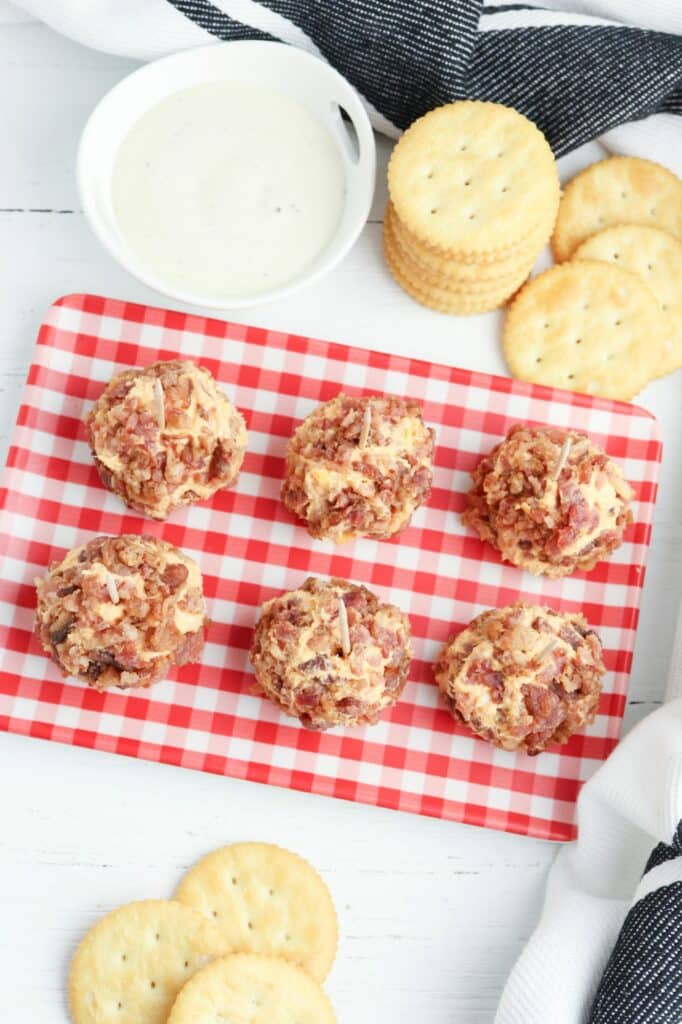 Meatballs on a tray with crackers and dip.