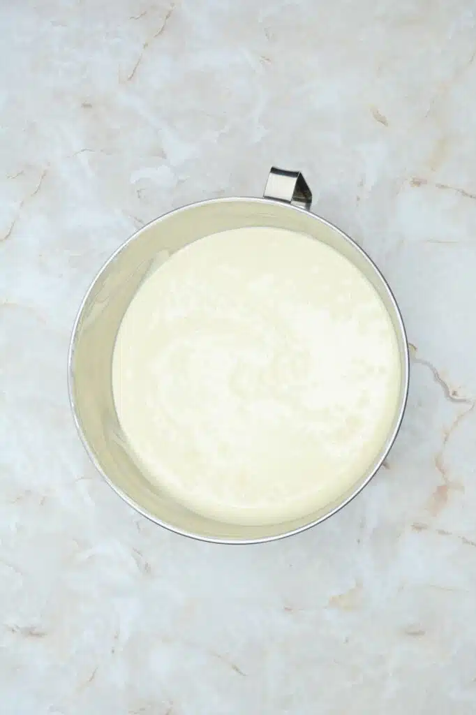 A bowl of cream on a marble surface.