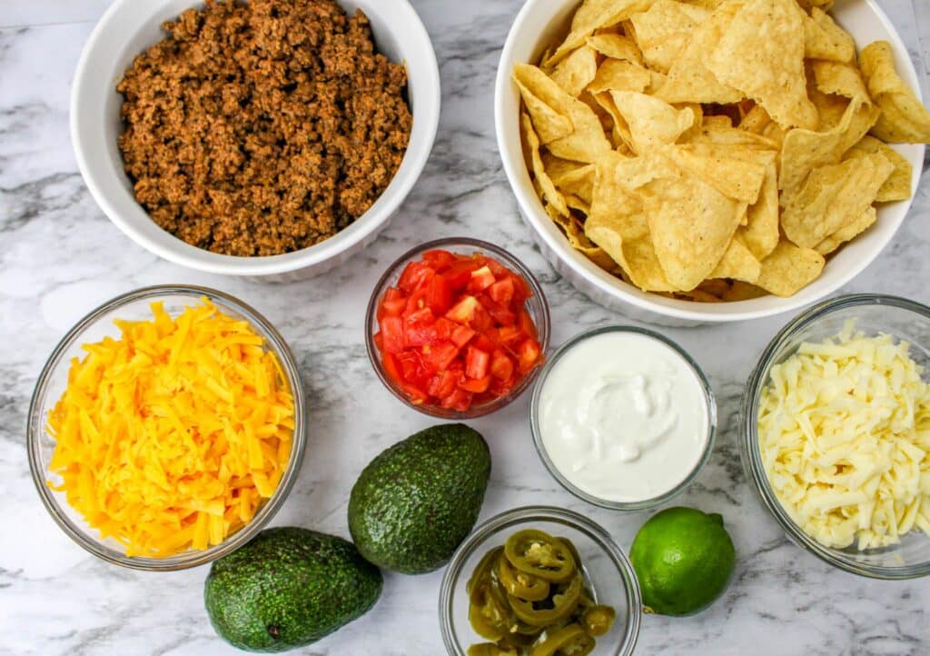 Ingredients for mexican tacos on a marble countertop.