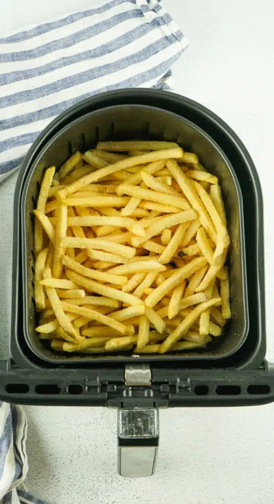 An air fryer filled with french fries.