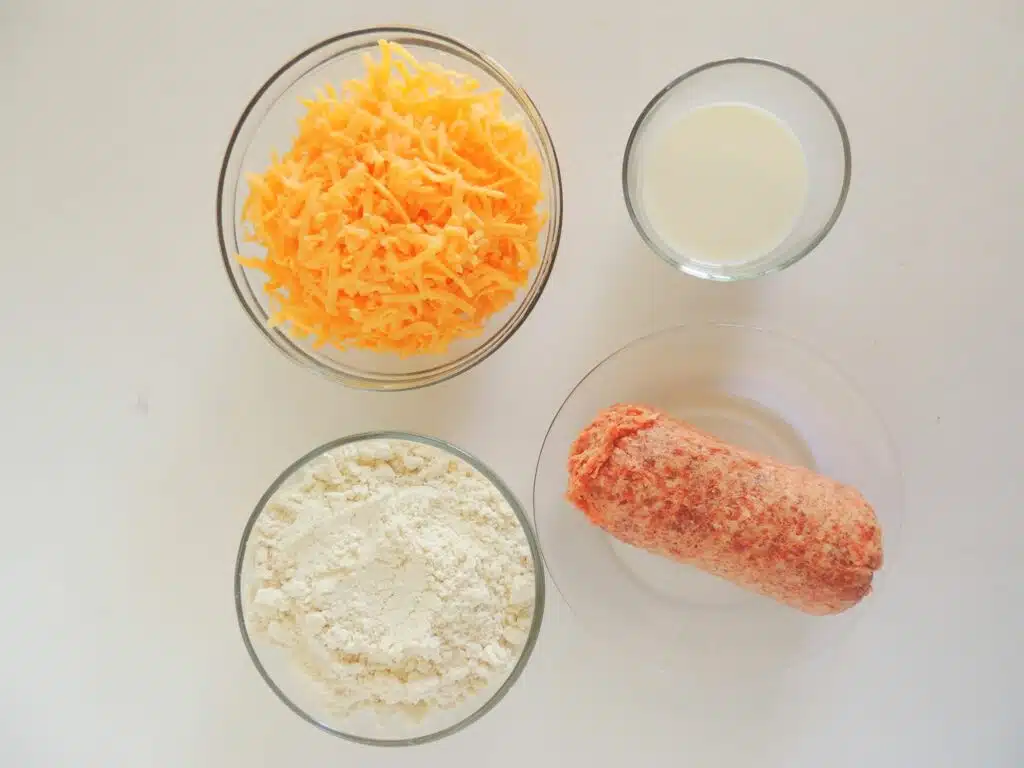 A bowl of cheese, eggs, bread crumbs and other ingredients for a meatloaf.