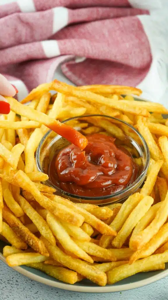 French fries with ketchup on a plate.