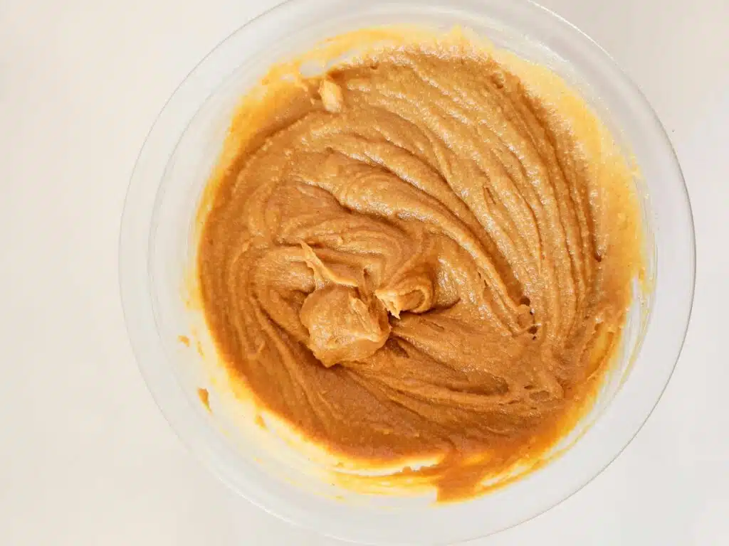 Peanut butter in a bowl on a white background.