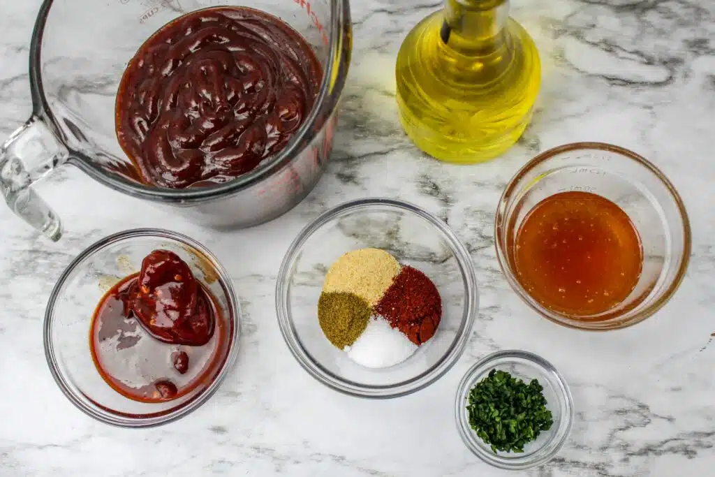 Ingredients for bbq sauce on a marble countertop.