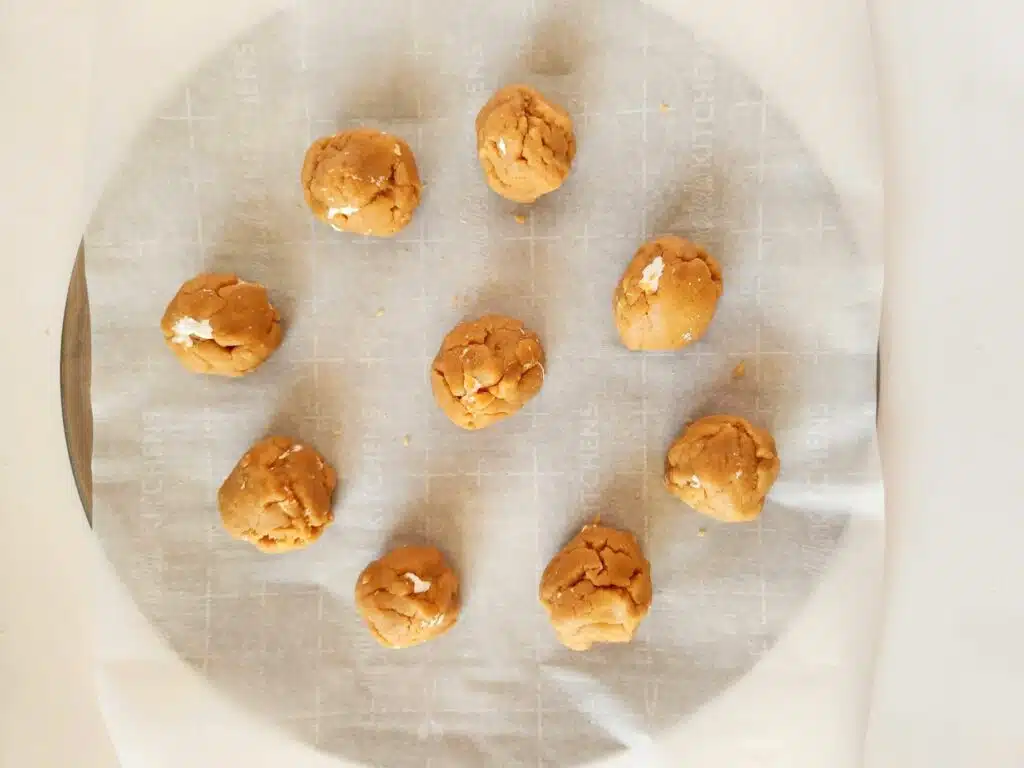 Peanut butter balls on a baking sheet.