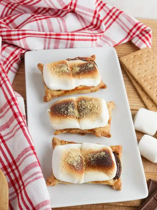 Three s'mores tarts on a white plate.