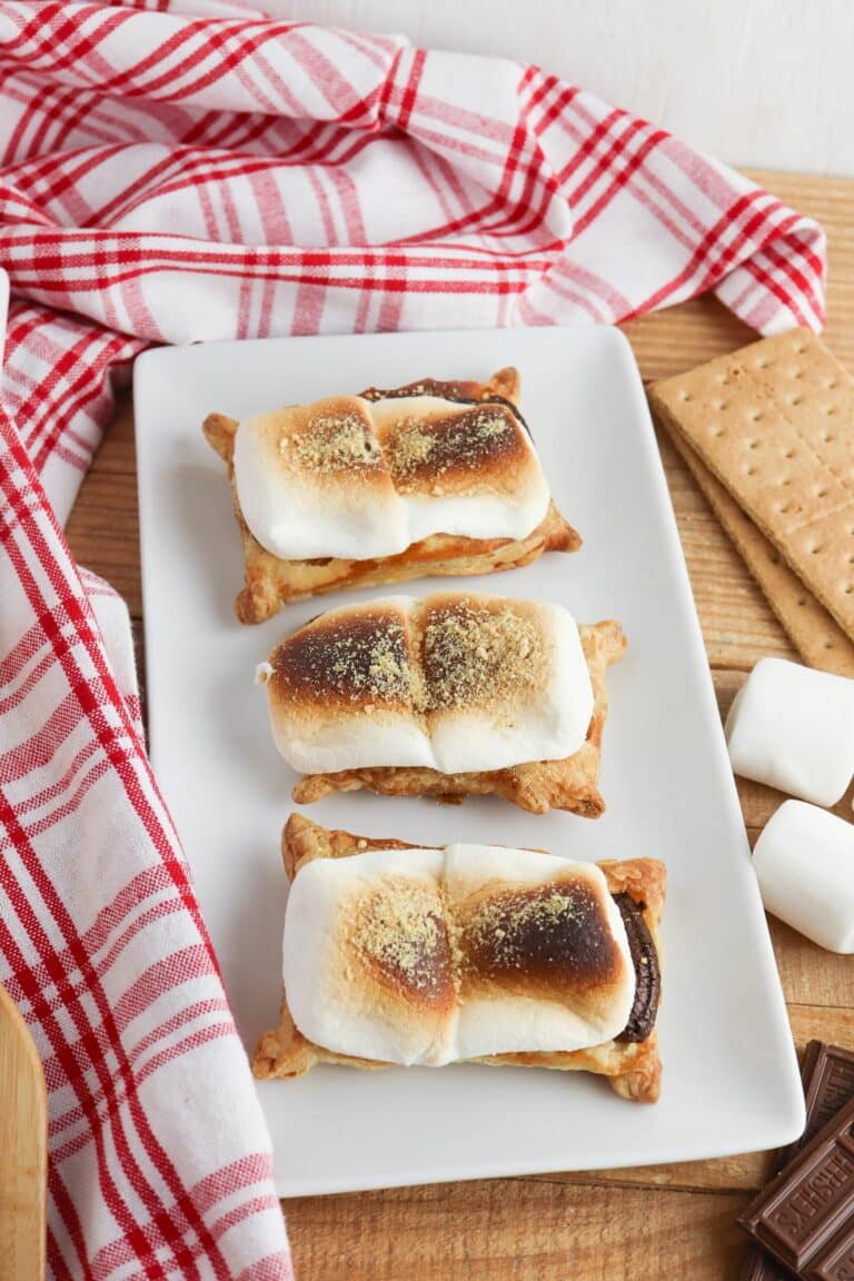 Three s'mores tarts on a white plate.