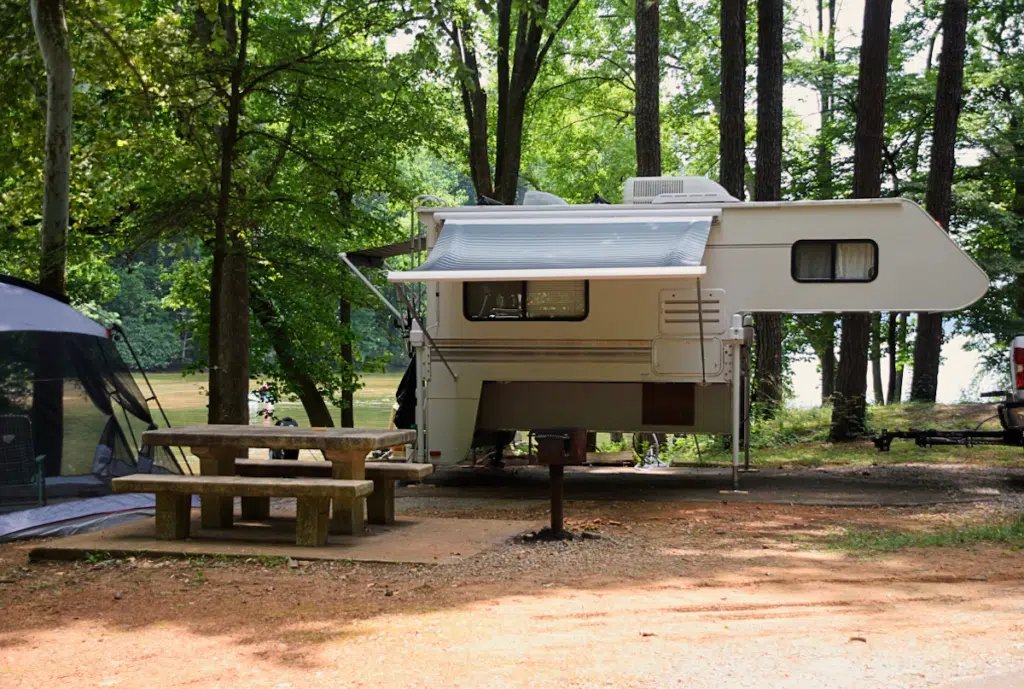 Truck camper at campsite detached from truck