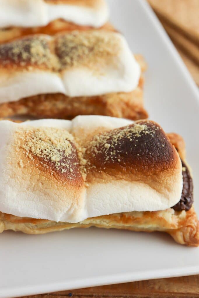 A plate of smores on a plate with chopsticks.