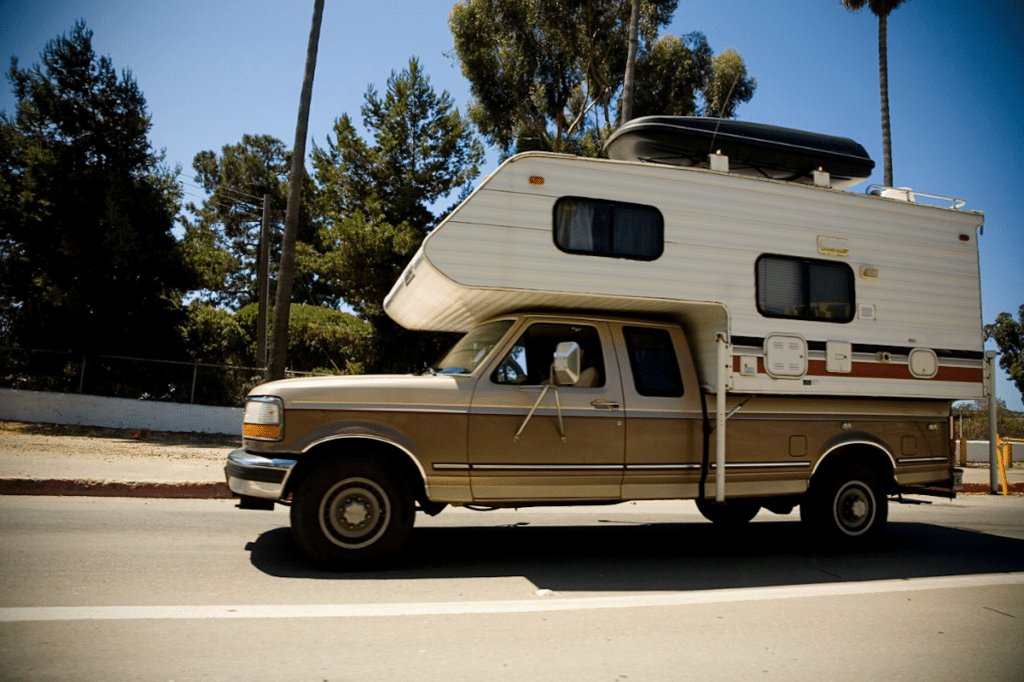 Vintage truck camper on highway