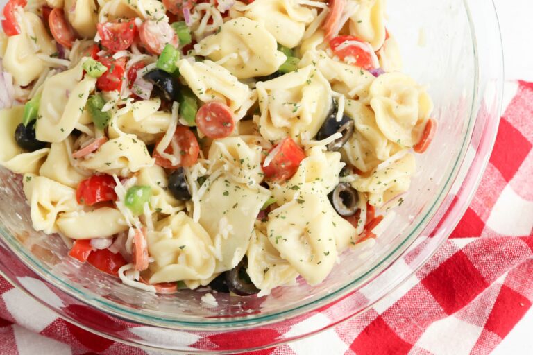Tortellini salad in a glass bowl.