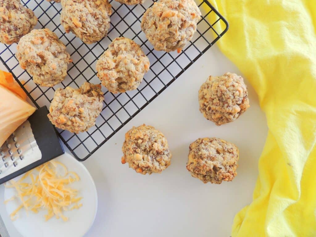 Cheesy meatballs on a cooling rack.