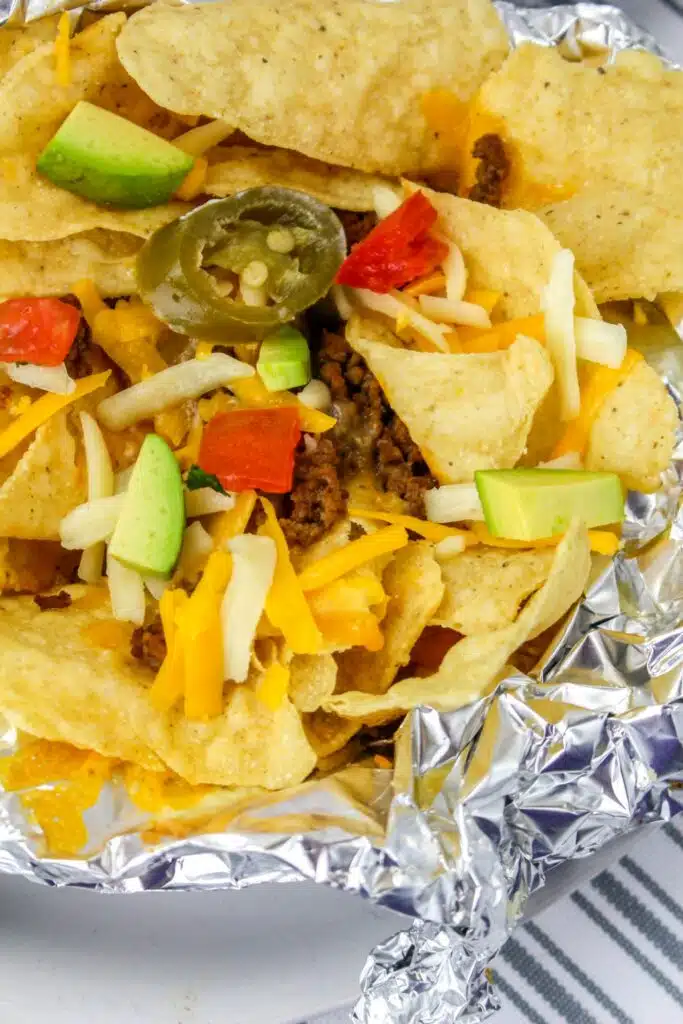 Nachos in foil on a plate.